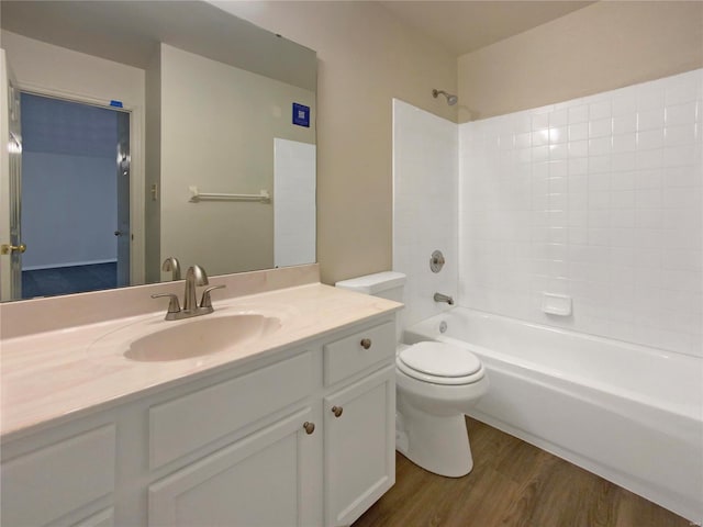 full bathroom featuring hardwood / wood-style floors, vanity, bathtub / shower combination, and toilet