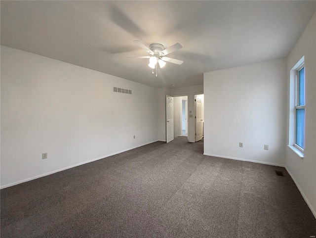 unfurnished bedroom with ceiling fan and dark colored carpet