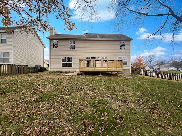 back of property featuring a yard and a deck