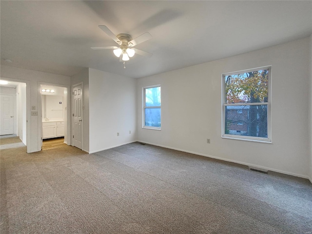 interior space with light colored carpet and ceiling fan