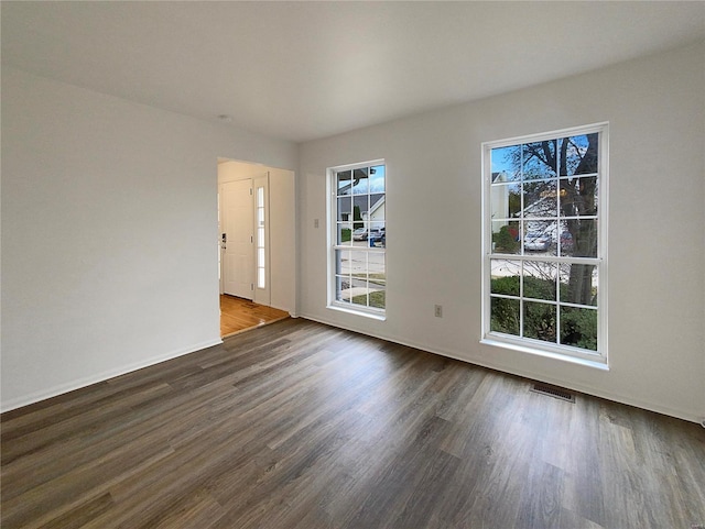 spare room with dark wood-type flooring