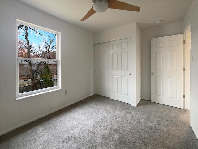 unfurnished bedroom with carpet flooring, ceiling fan, and a closet