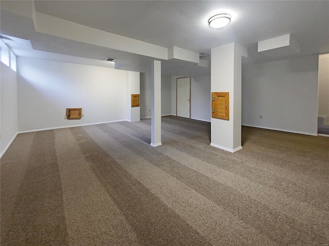 basement with dark colored carpet