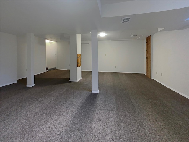 basement with dark colored carpet