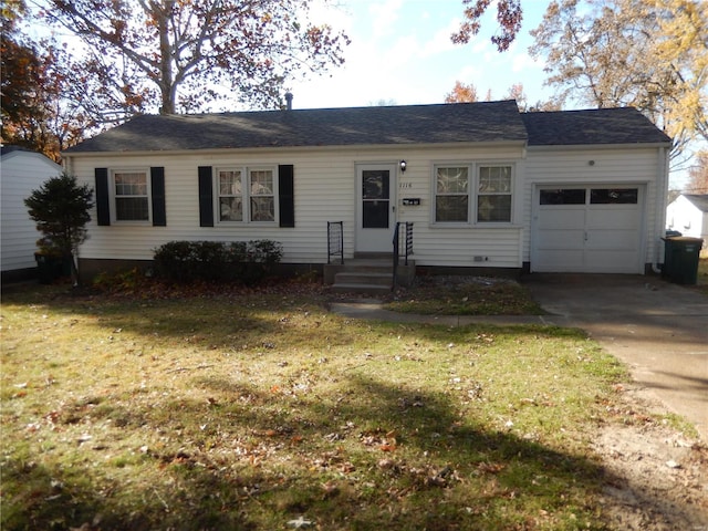 single story home with a front yard and a garage