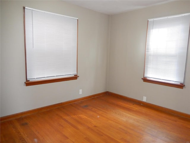 unfurnished room with hardwood / wood-style floors