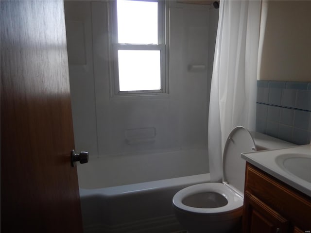 full bathroom with shower / bath combo, vanity, tile walls, and toilet