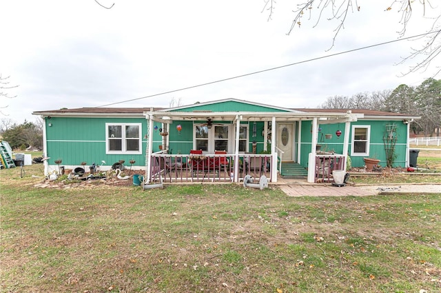 view of front of property with a porch and a front yard