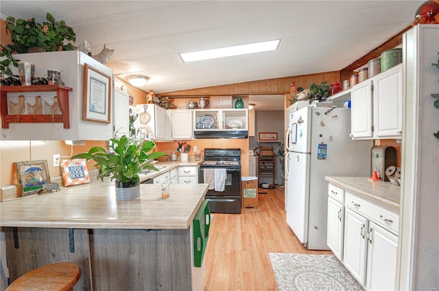 kitchen featuring kitchen peninsula, vaulted ceiling, electric range, light wood-type flooring, and white cabinetry