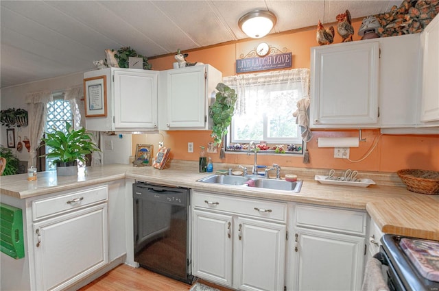 kitchen with white cabinetry, dishwasher, light hardwood / wood-style floors, and sink