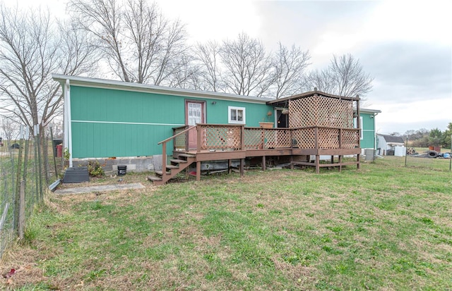 view of front facade with a wooden deck and a front lawn