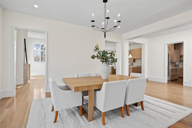 dining area featuring light hardwood / wood-style flooring and a chandelier