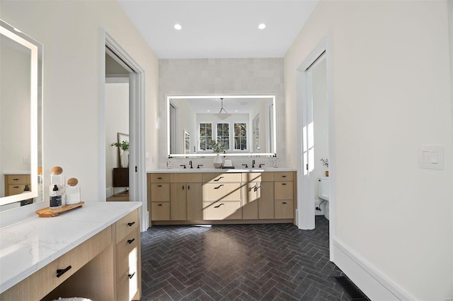 bathroom featuring vanity and toilet