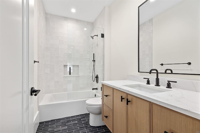 full bathroom with vanity, toilet, and tiled shower / bath combo