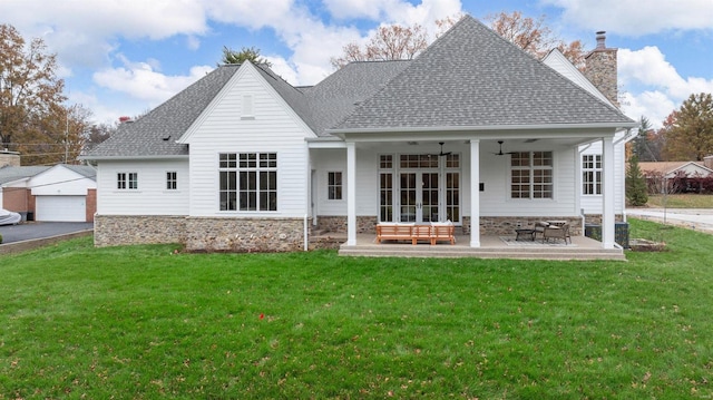 rear view of house with french doors, ceiling fan, a patio, and a lawn