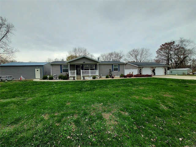 view of front of home with a front yard, a porch, and a garage