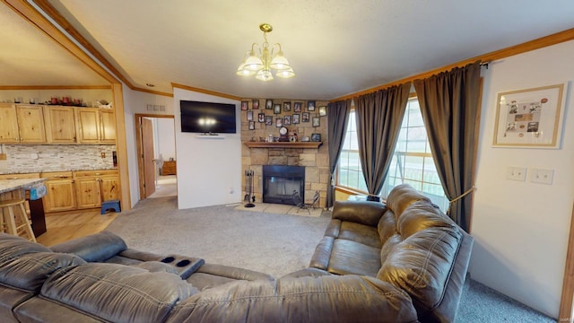 carpeted living room with a chandelier, vaulted ceiling, ornamental molding, and a stone fireplace