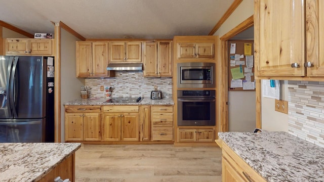 kitchen featuring light stone countertops, stainless steel appliances, tasteful backsplash, light hardwood / wood-style flooring, and ornamental molding