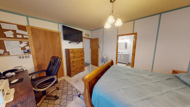 bedroom with a chandelier, a closet, and light colored carpet