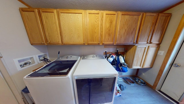 washroom with cabinets, independent washer and dryer, a textured ceiling, and ornamental molding