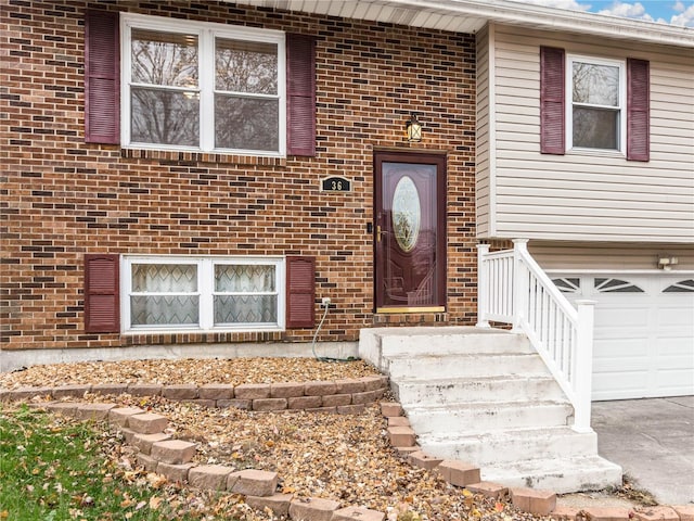 doorway to property with a garage