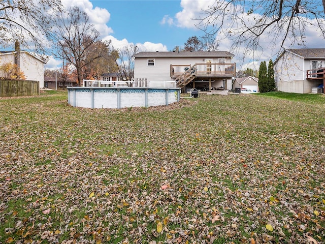 back of house with a lawn and a pool side deck