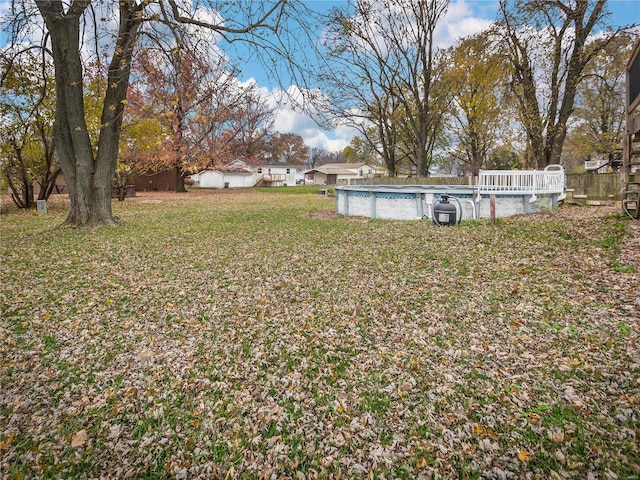 view of yard with an empty pool