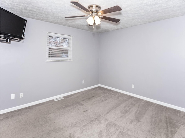 unfurnished room featuring ceiling fan, carpet floors, and a textured ceiling