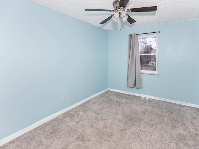 carpeted spare room with ceiling fan and a textured ceiling