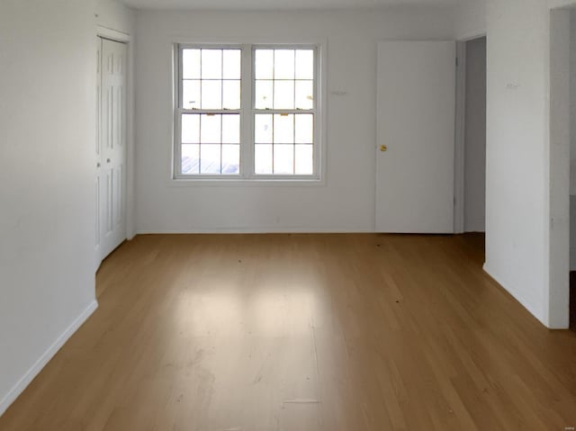 empty room with light hardwood / wood-style flooring