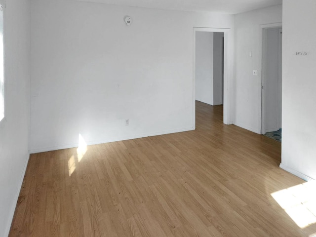 unfurnished room with light wood-type flooring