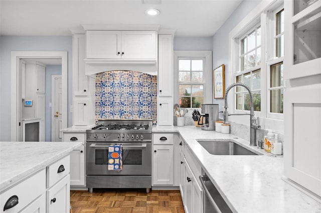 kitchen featuring light stone countertops, sink, white cabinets, and stainless steel appliances