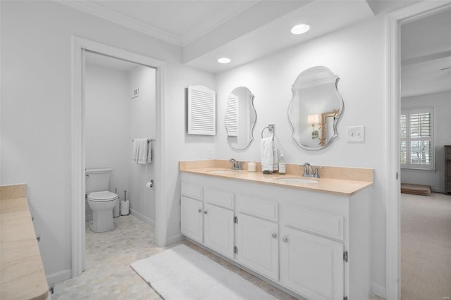 bathroom featuring vanity, ornamental molding, and toilet