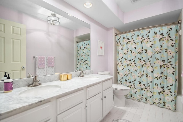 bathroom featuring toilet, vanity, and tile patterned floors