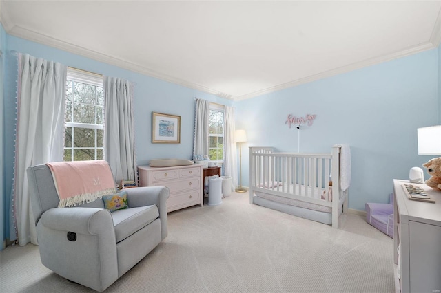 carpeted bedroom with a crib, ornamental molding, and multiple windows