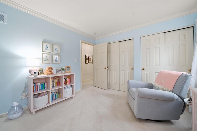 sitting room featuring light colored carpet and crown molding