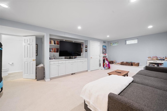 carpeted living room with built in features