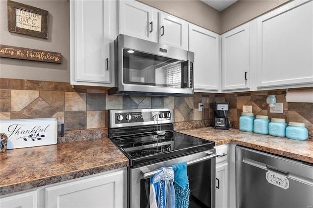 kitchen featuring decorative backsplash, white cabinetry, and stainless steel appliances