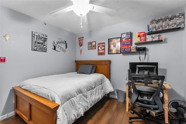 bedroom featuring ceiling fan, dark hardwood / wood-style flooring, and a textured ceiling