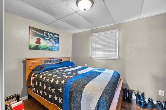 bedroom with dark hardwood / wood-style floors