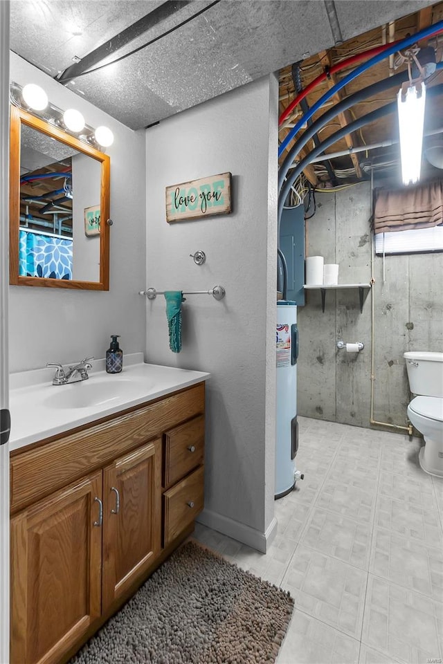 bathroom featuring vanity, toilet, and electric water heater