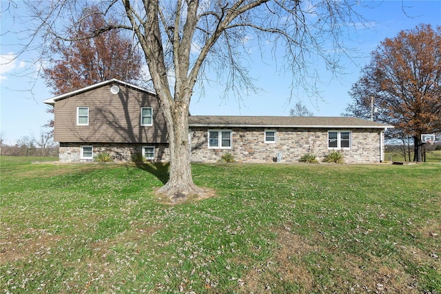 back of house with a lawn