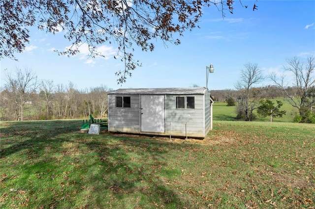 view of outbuilding with a lawn