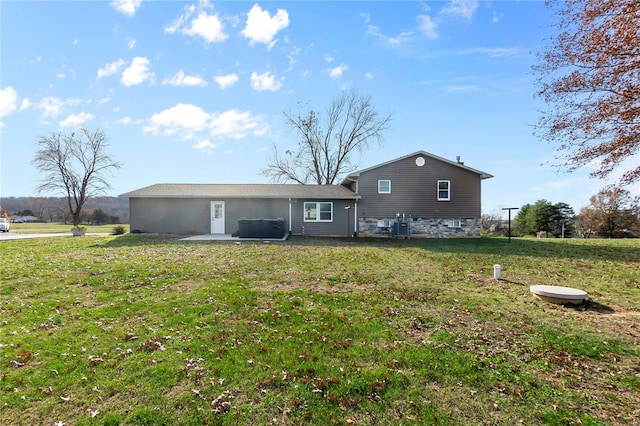 back of property featuring a lawn