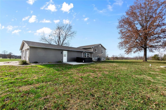 rear view of property with a patio area and a yard