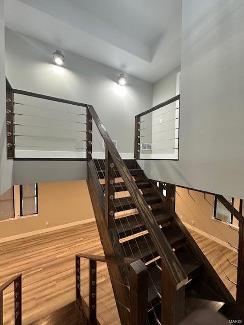 staircase with wood-type flooring