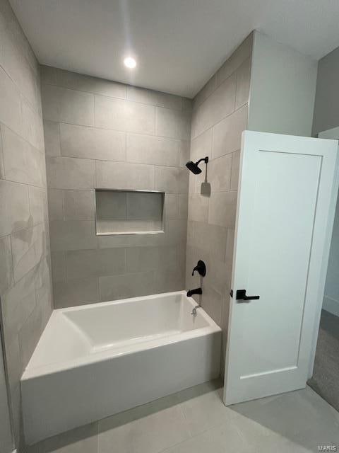 bathroom with tile patterned floors and tiled shower / bath