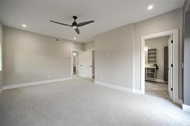 unfurnished bedroom featuring ceiling fan and light carpet