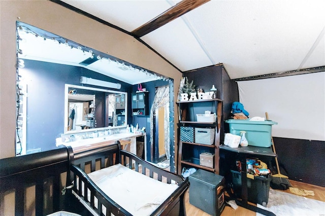 bathroom featuring hardwood / wood-style flooring and vaulted ceiling with beams