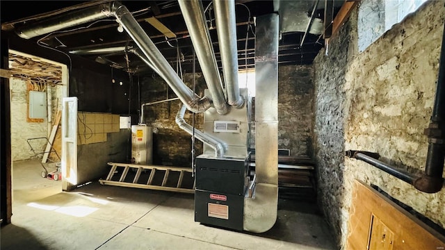 utility room featuring gas water heater and electric panel